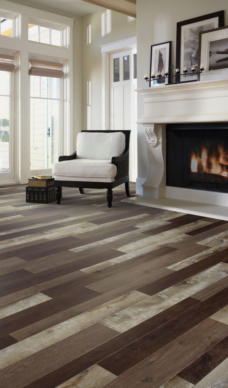 Mix of flooring colors in contemporary living room with fireplace and floor to ceiling windows