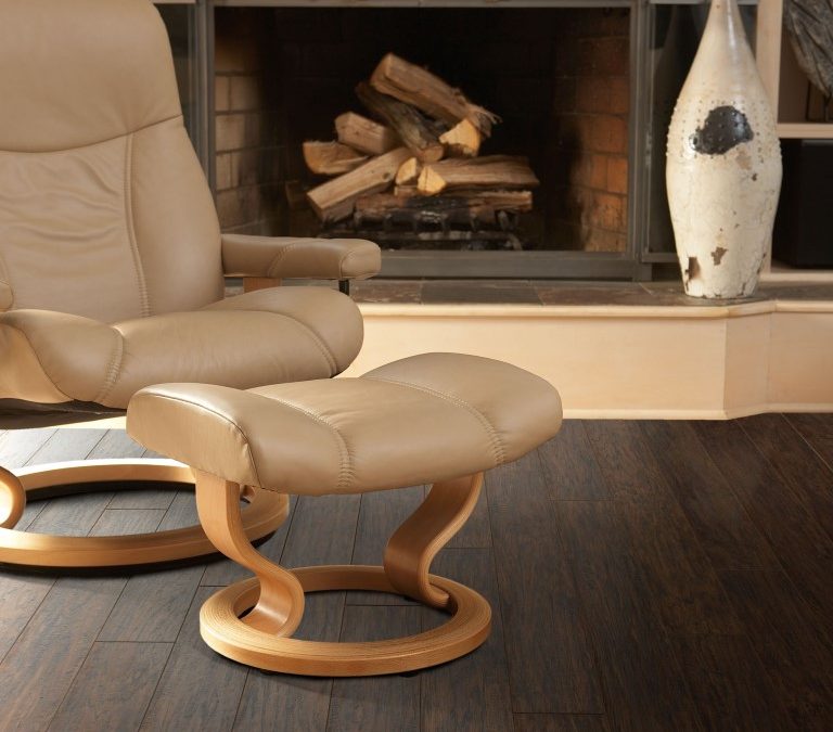 Dark flooring by fireplace and modern chair