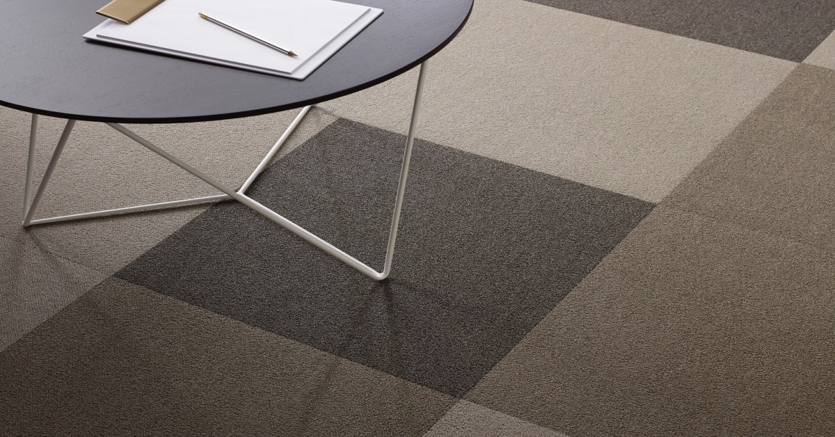 Close up of high quality carpet tiles in various colors and patterns highlighting their durability and noise dampening features
